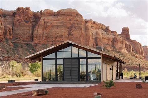 A glass pavilion venue set against red-rock cliffs