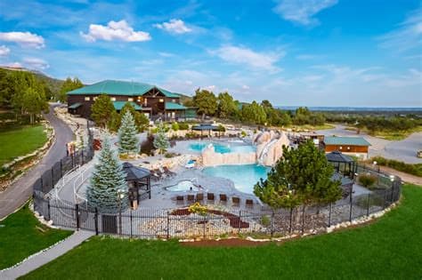Resort lodging with pool below red-rock mesas